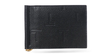 A black lambskin Trevony Intimo bill clip wallet with embossed monogram design, featuring a visible gold-tone money clip on the side.