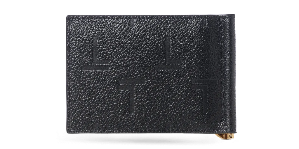 A black lambskin leather Trevony Intimo bill clip wallet with embossed monogram design, featuring a visible gold-tone money clip on the side.