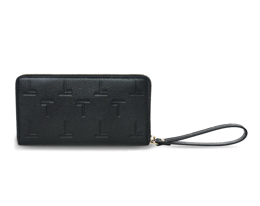 A black lambskin long wallet with an embossed monogram pattern and a wrist strap, featuring a gold-tone metal logo and hardware from Trevony.